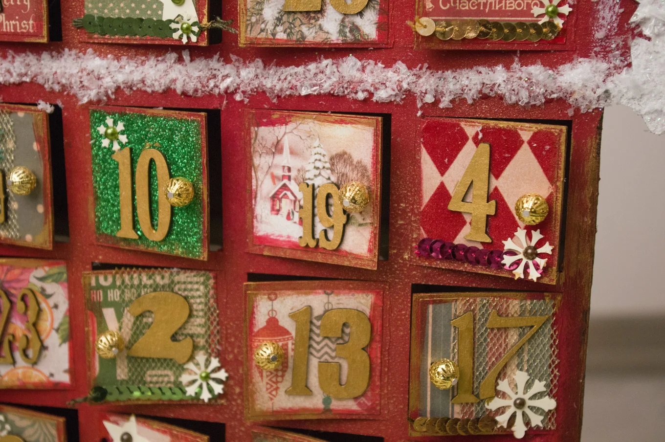 Advent calendar squares with numbers and decor.